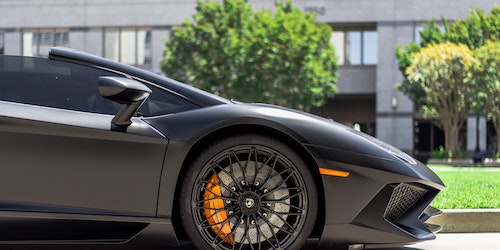 A Lamborghini's front wheel and panel in profile