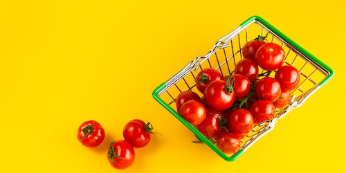 A shopping basket, filled with plump tomatoes