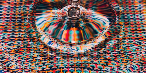 A drop of water against a colorful background