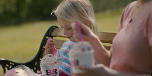 Little girl eating Baskin Robbins ice cream in a cup